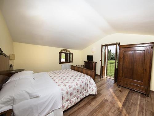 a bedroom with a white bed and a sliding glass door at Le Case Resort in Macerata