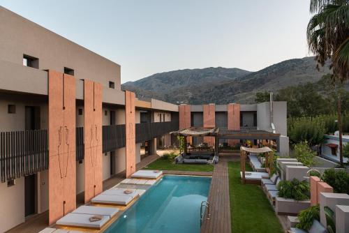 a hotel with a swimming pool and a resort at Pilot Amphora Boutique Hotel "Adults Only" in Georgioupolis