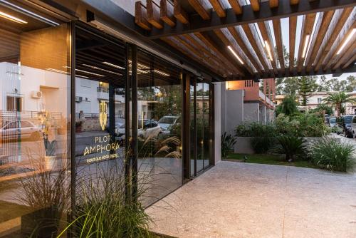 an entrance to a building with a sign on the door at Pilot Amphora Boutique Hotel "Adults Only" in Georgioupolis