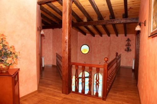 a hallway with a wooden staircase in a house at El Torreón del Búho in Arenas de San Pedro