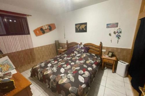 a bedroom with a bed with a comforter on it at Costa Calma Apartment OASIS in Costa Calma