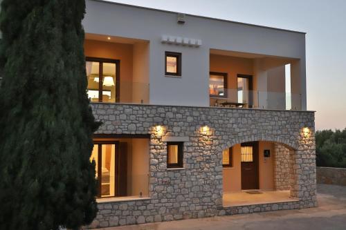 a house built on top of a stone wall at NiMar Villa in Sitia