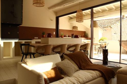a living room with a couch and a table at Loft Augustine in Leucate