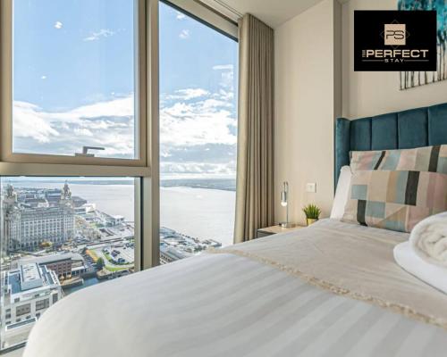 a bedroom with a bed and a large window at The Lexington - Luxury Serviced Apartments City Centre - City and Waterfront views in Liverpool