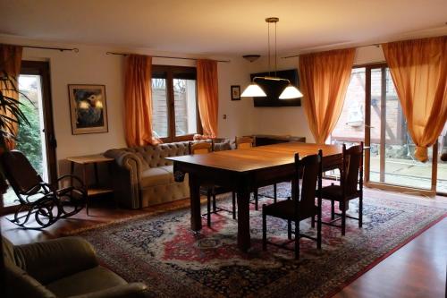 a dining room with a wooden table and chairs at Apartament Bilard nad Bałtykiem in Gdynia