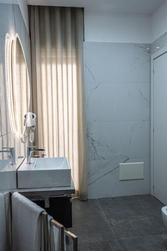 a bathroom with a sink and a mirror at Heaven House in Sant'Egidio del Monte Albino