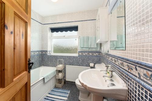 a bathroom with a sink and a toilet and a tub at Cottage 207 - Ballyconneely in Ballyconneely