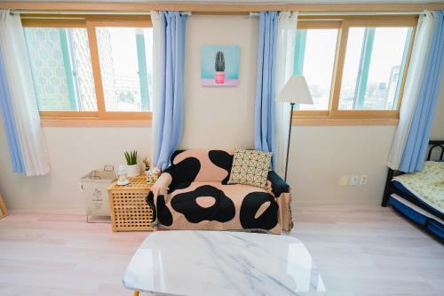 a bedroom with a bed with a cow blanket on it at Sweet Stay in Seoul