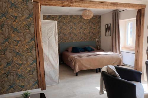 a bedroom with a bed and a mirror at La Maisonnette de l Espace Themis, piscine partagée in Saint-Germain-de-Salles