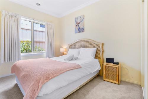 a bedroom with a large bed and a window at 4 bedrooms house walking to shopping town#20A in Doncaster