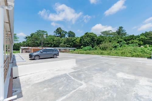 a car parked on top of a parking lot at Sans Hotel Berau Square in Tanjungredep