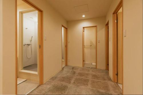 a bathroom with a walk in shower and a mirror at Mash Cafe & Bed NAGANO in Nagano