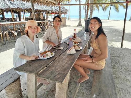 a group of women sitting at a picnic table on the beach at Gunayar amazing in Arritupo Número Dos
