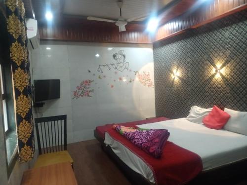 a hotel room with a bed and a tv at Hotel Geetanjali St Bus Stand Panvel in Panvel