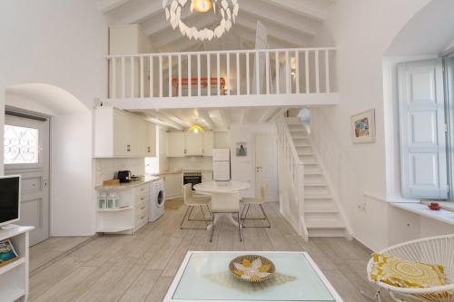 a kitchen and living room with a spiral staircase at Gaia accomodation Hydras in Hydra