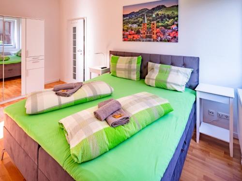 a large bed with two pillows on top of it at Haus der Kaiser in Goslar