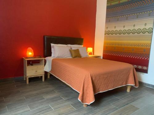 a bedroom with a bed and a red wall at Casa Madero Beautiful 2BR apt one Block from Malecón! Best Location! in La Paz