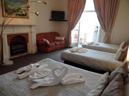 a hotel room with two swans made out of towels at Charlotte Guest House in London