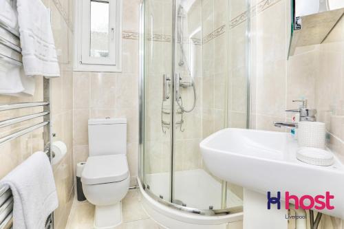 a bathroom with a shower and a toilet and a sink at Host Liverpool - Chic family spot, near Anfield & centre in Liverpool