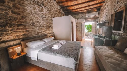 a bedroom with a bed and a couch in a room at The Cellar Studios - by Avelink in Spata