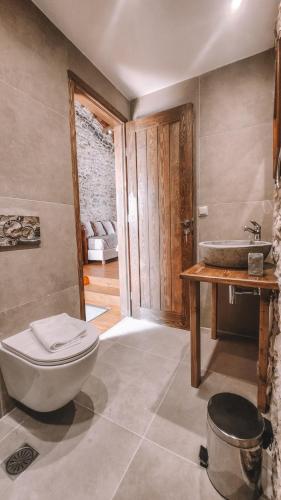 a bathroom with a toilet and a sink at The Cellar Studios - by Avelink in Spata