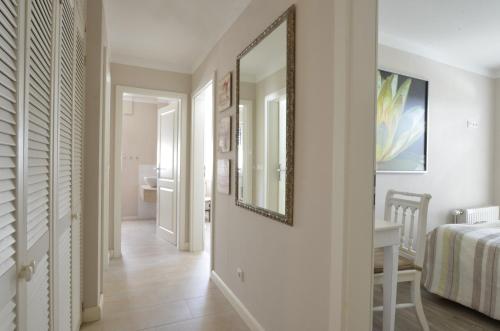 a hallway with a mirror and a bed and a table at Strandperle 9, PP außen in Zingst