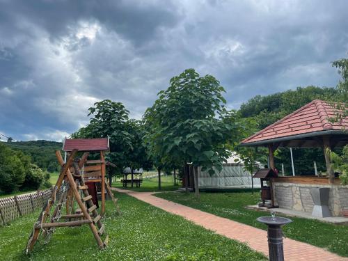 a playground with a wooden ladder and a gazebo at Nomád jurta Zalakaros mellett in Zalamerenye