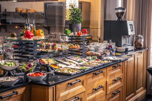 a buffet line with many different types of food at Mercure Wiazowna Brant in Wiązowna