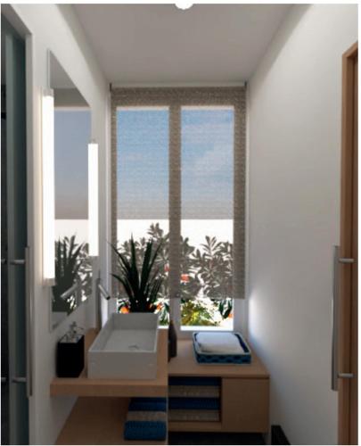 a bathroom with a window with a sink and a plant at A 10 minutes à pied du stade de France , 35 m2 très cosy refait à neuf in Saint-Denis