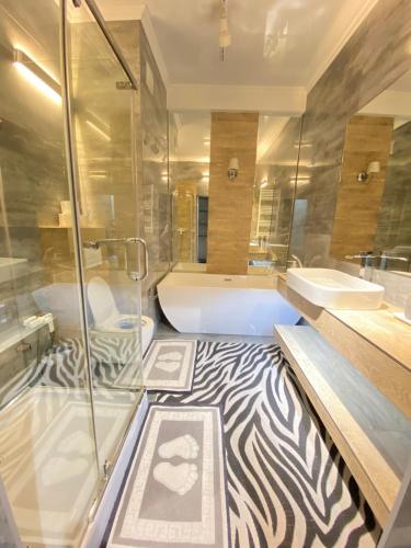 a zebra themed bathroom with a tub and a zebra rug at Ultracentral Lux Apartment in Chişinău