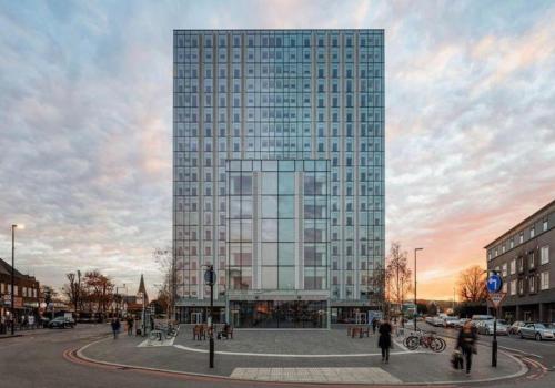 a tall building with people walking in front of it at 2BR Chic London Sleep 9 BP7 in London