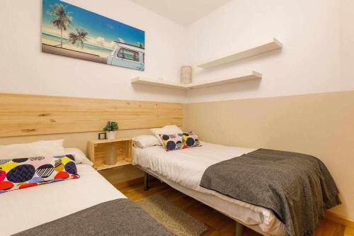 ein Schlafzimmer mit 2 Betten und einem Wandgemälde in der Unterkunft A&N La Vega 2 in Torre del Mar