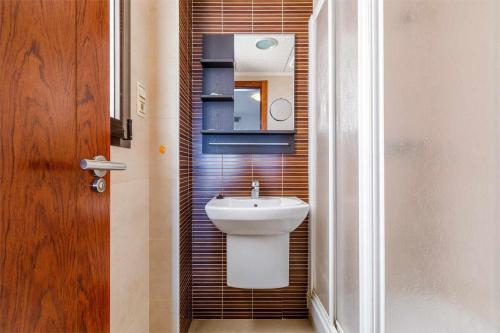 a bathroom with a white toilet and a sink at A&N Seaport 1B in Caleta De Velez