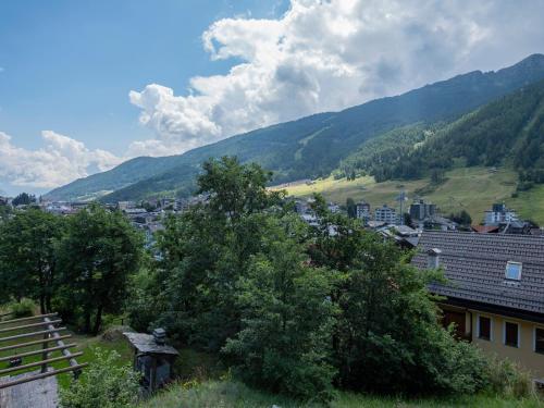 a view of a city with mountains in the background at Dosso Aprica Apartment in Aprica