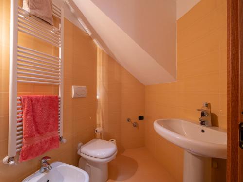 a small bathroom with a sink and a toilet at Dosso Aprica Apartment in Aprica