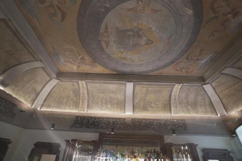 a ceiling with a painting above a bar at Palazzo Santo Spirito in Bergamo