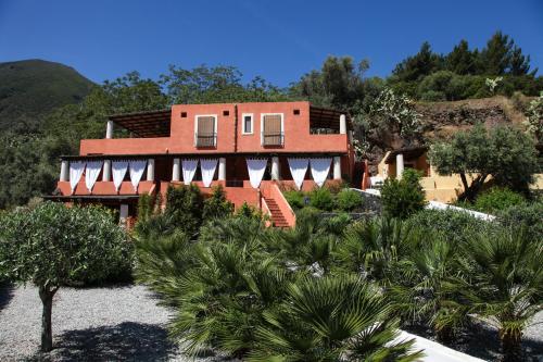 a house with a lot of trees in front of it at Residence Salina in Malfa