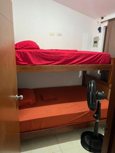 a room with two bunk beds and a fan at Departamento Tonsupa Nacabez I in Esmeraldas