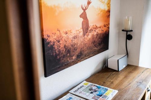 a picture of a deer hanging on a wall at La Tgoma - Hotel & Restaurant in Lenz