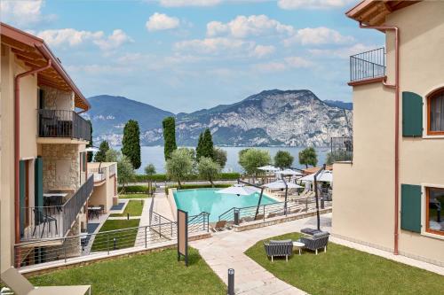 a view from the balcony of a resort with a pool at June Stay Lake Garda in Brenzone sul Garda