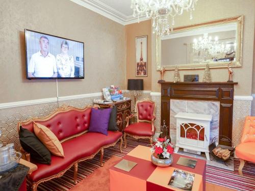 a living room with a couch and a fireplace at The Llandudno Hotel in Llandudno