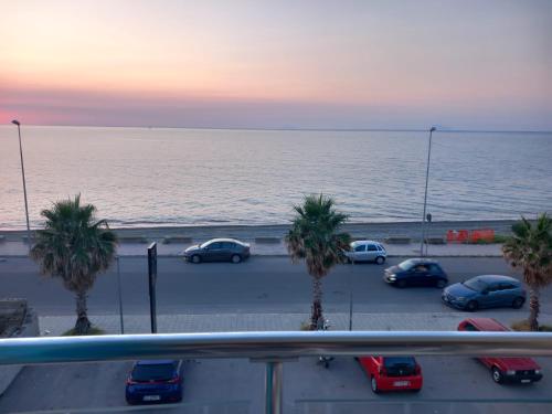 a group of cars parked in a parking lot near the ocean at Casa Maris in SantʼAgata di Militello
