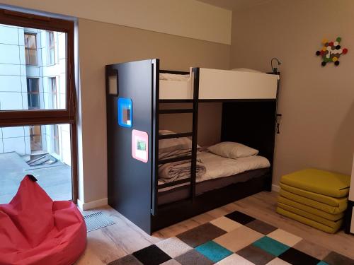 a room with two bunk beds and a window at Apartament PORTA MARE 115 Wes Quality Suite in Dziwnówek