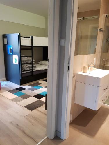 a bathroom with a sink and a bunk bed at Apartament PORTA MARE 115 Wes Quality Suite in Dziwnówek