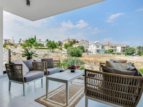 a patio with chairs and a table and a view at Sanders Elgio in Limassol