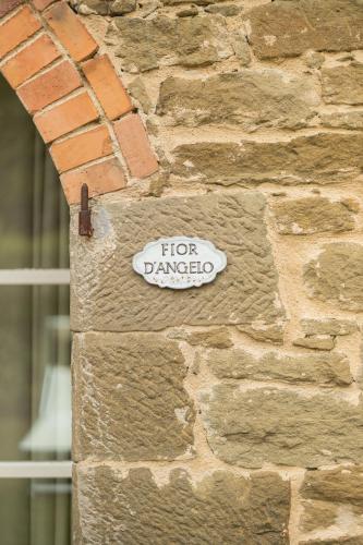 a sign on the side of a brick wall at Villa di Piazzano - Small Luxury Hotels of the World in Cortona