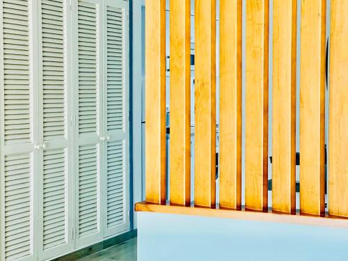a wooden wall with white shutters on a building at Canaryislandshost l Sal de Mar in Puerto del Carmen