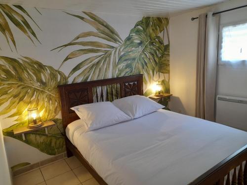 a bedroom with a bed with two lamps on tables at LeS GITES CAMBOIS in Cambes