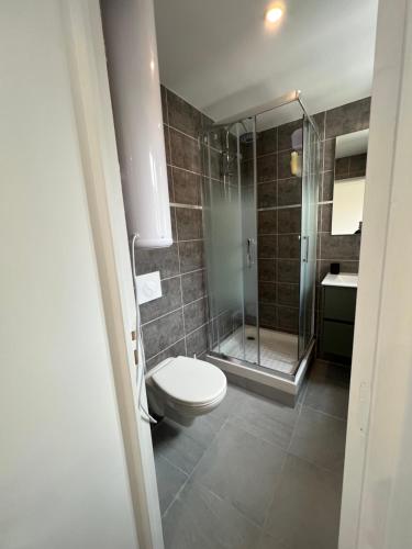 W łazience znajduje się toaleta i przeszklony prysznic. w obiekcie Joli studio w mieście Le Pré-Saint-Gervais