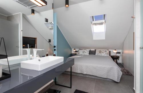a bedroom with a sink and a bed and a tub at Villa Sanja in Postira